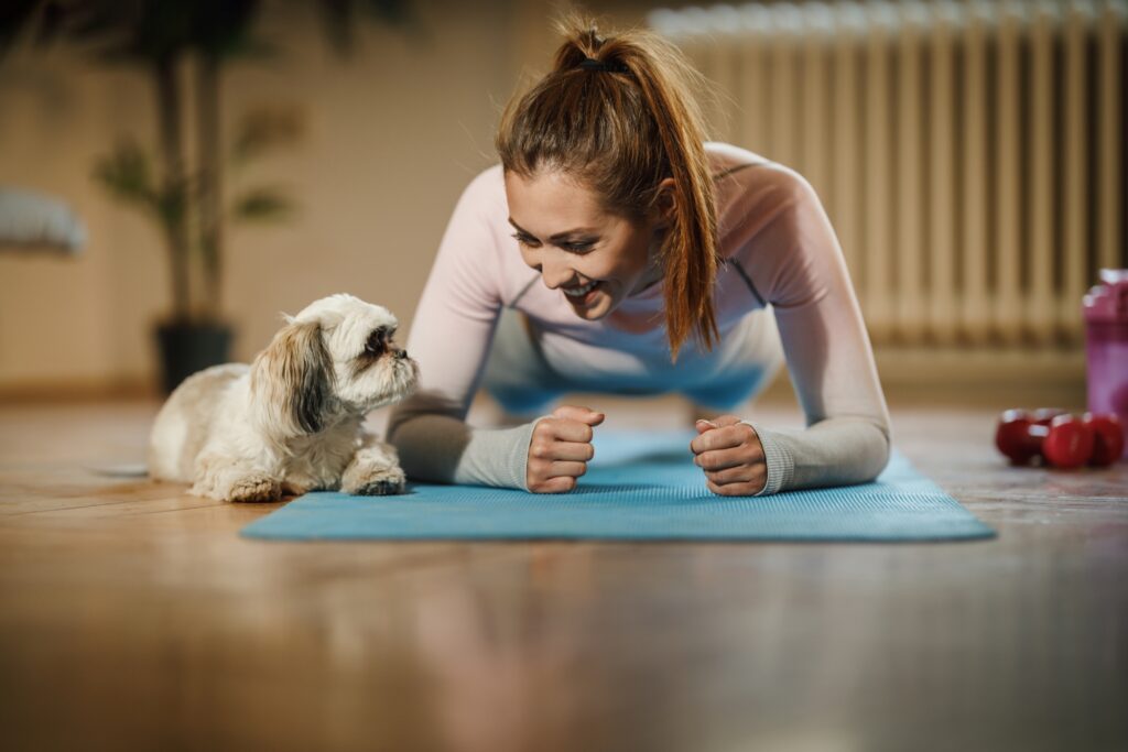 A woman is working at home with her pet