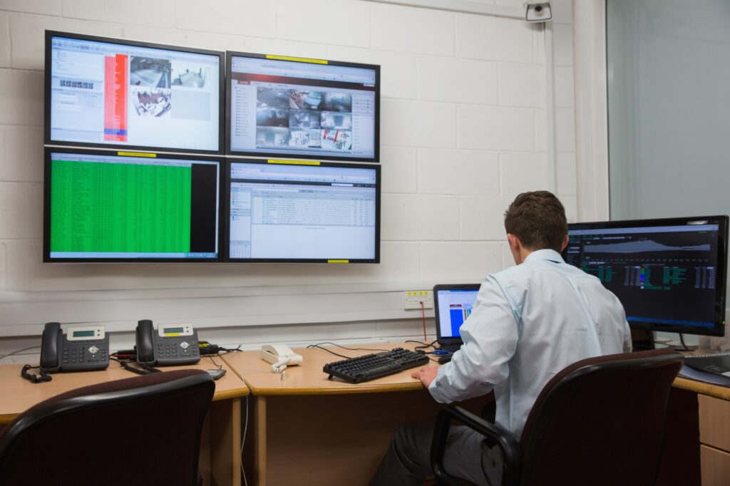 Technician inside the office with multiple computers in the concept of 'How to Pack Office IT Equipment and Electronics Safely for Your Move to Wembley'.